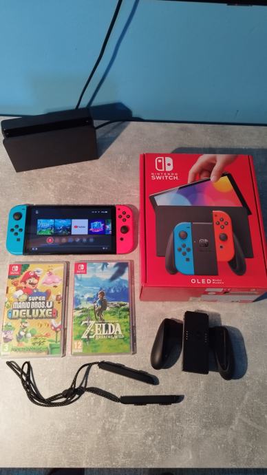 Nintendo Switch OLED (red/blue) + 2 igrice (Super Mario Bros., Zelda)